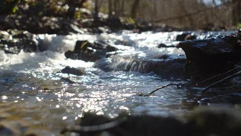 Close up of mountain water stream or river runs down hill at early spring Stock Footage 303957727