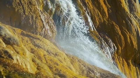 Close up of a mountain waterfall slowly flows into the sea in slow motion. Stock Footage 84228868
