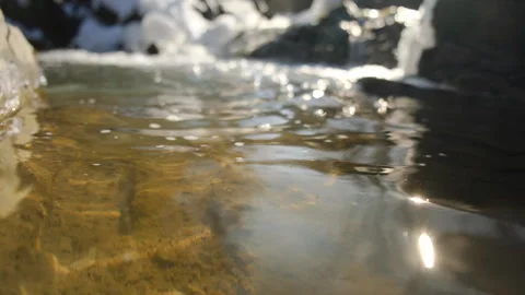 Close up of mountains river water flowing during sunny winter day with foamy Stock Footage 301366011