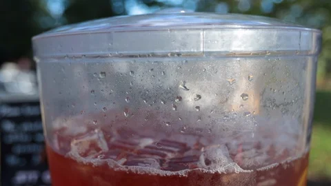 Close move down on large elegant container of tea or punch with citrus fruit Stock Footage 96540087