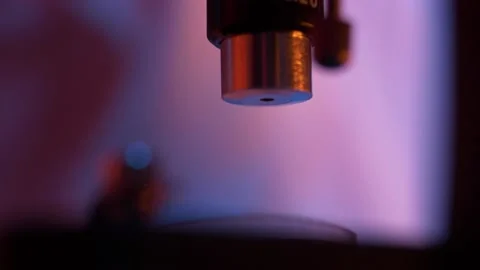 Close-up of movement of a microscope objective. Detail of medical equipment. Video stock 143329414