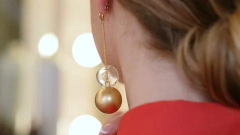 Close up of a moving earring in the ear of beautiful woman Video stock 105050468