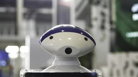 Close up of the moving humanoid robot with a camera on his head. Media. New Stock Photos