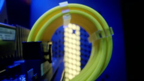 Close-up moving macro shot of the coil of yellow cable in gaming computer. 库存影片 203960970