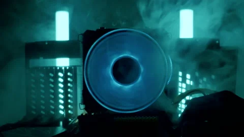 Close-up moving macro shot of spinning glowing cooler in computer. Steam flows Stockbeeldmateriaal 202653484