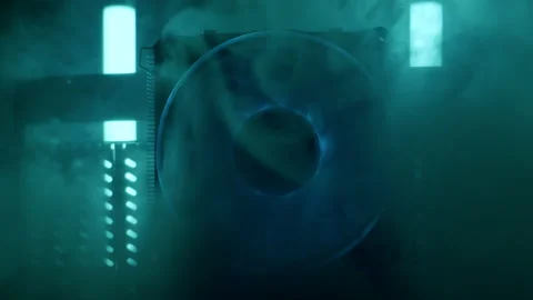 Close-up moving macro shot of spinning glowing cooler in computer. Steam flows. Stock Footage 203961084
