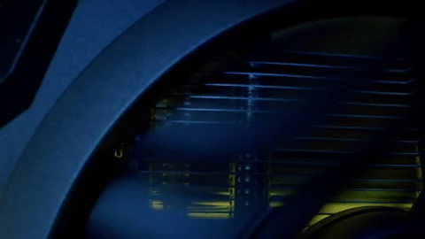 Close-up moving macro shot of the spinning glowing cooler in gaming computer Stockbeeldmateriaal 205044596