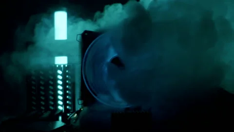 Close-up moving macro shot of spinning glowing cooler in a computer. Steam flows 库存影片 205044634