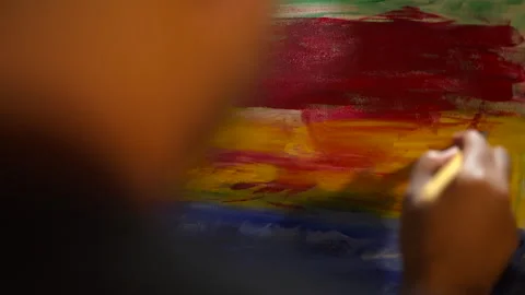 Close-up Moving Paint brush holding on hand of artist and painting on canvas wor Stock Footage 243722041