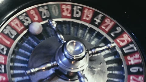 Close-up of a Moving Roulette Wheel with Ball Landing on black Number Vídeo Stock 335891680