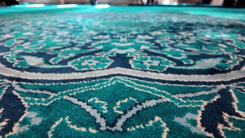 Close up moving shot of a plush turquoise carpet with intricate patterns in.. Vídeos de archivo 332056684