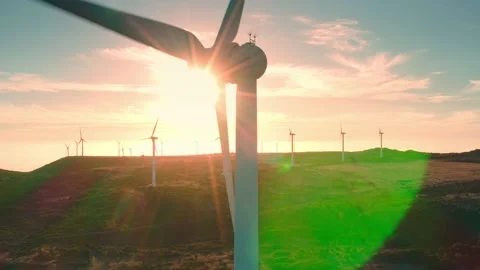 Close up moving wind turbine at the sunset and many windmills at the background Stock Footage 196473930