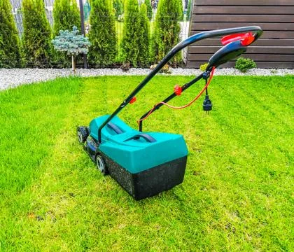 A close up of a mower in a backyard 스톡 사진