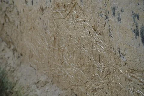 Close up of mud and straw wall texture used in traditional rural construction in Stock Photos