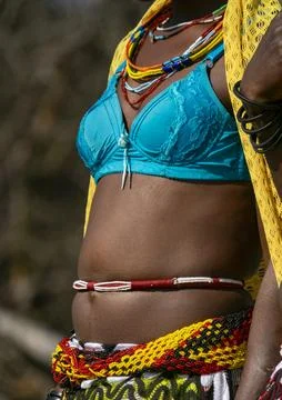 Close-up of a Mudimba tribe woman's torso adorned with beaded necklaces and.. Foto stock