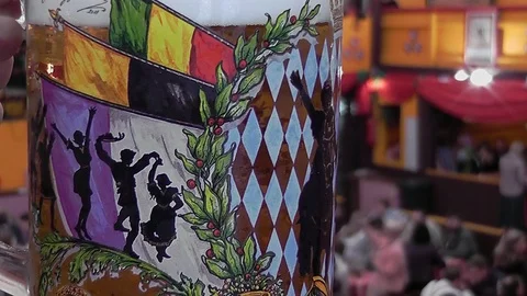 Close-up of a mug of beer inside a hangar at the Oktoberfest Stock Footage 94823135