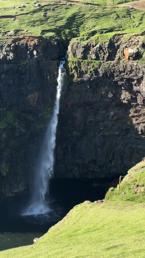 Close-up of Mulafossur waterfall cascading into Atlantic Ocean, Vagar Island Video stock 331254241