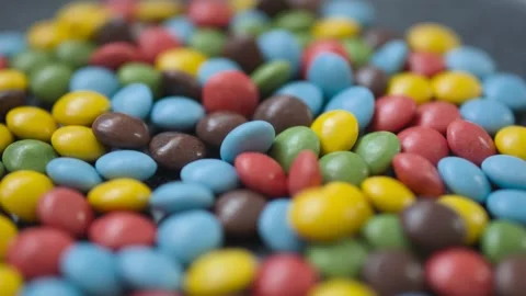 Close-up of multi-colored button-shaped bonbon chocolates Stock Footage 296321196