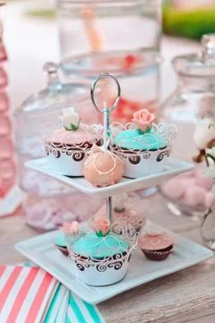 Close-up of multi colored cupcakes on many tier pedestals ready for a picnic, Stock Photos