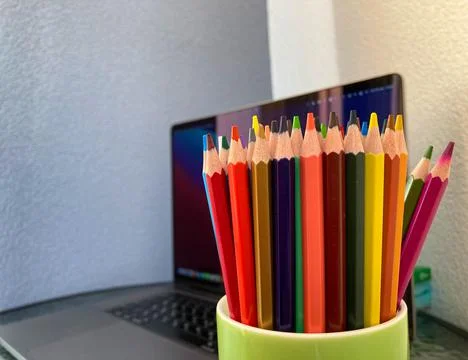 Close-up of multi-colored pencils stand in a green cup. Stock Photos