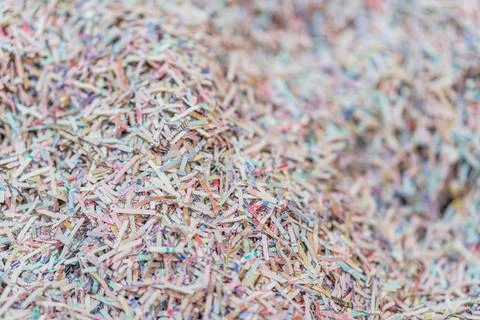 Close-up of multi-colored shredded paper, densely packed, in chaotic texture, Foto stock