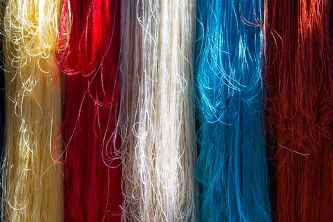 Close up of multi colored silk threads. Yellow, red, white and blue Stock Photos