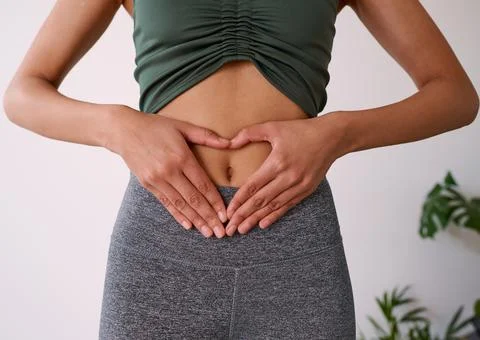 Close up of a multi-ethnic woman's hands on her stomach Stock Photos