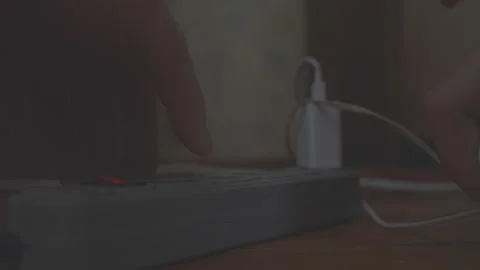 Close up of a multi socket adapter being plugged in and turned on Stock Footage 298358700