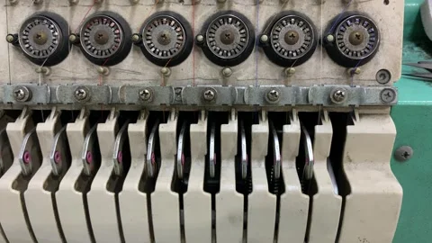 Close up of a multi thread textile machine featuring tension control 動画素材 346360179