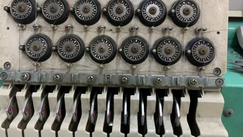 Close up of a multi thread textile machine featuring tension control Stock Footage 346812893