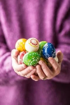 Close-up multicolored easter eggs in the senior woman hands Stock Photos