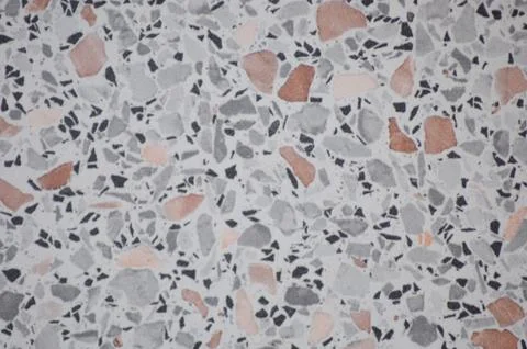 Close-up of multicolored marble chips on a gray valuable screed. Stock Photos