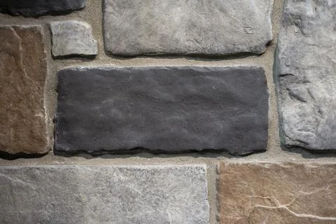 Close-Up of Multicolored Stone Veneer Wall with Dark Gray Accent Stone Textur Stock Photos