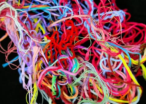 Close-up of multicolored tangled threads for needlework on black background Stock Photos