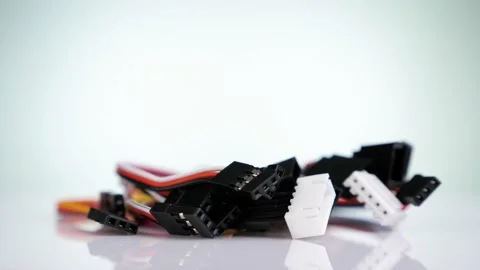 Close up of multicoloured connecting wires rotating on a white background Stock Footage 130971578