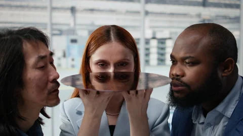 Close up of multiethnic technicians assessing semiconductor substrate quality Stock Footage 335880659