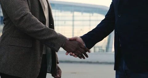 Close up of the multiethnical male hands shaking when two handsome businessmen Stock Footage 100450076
