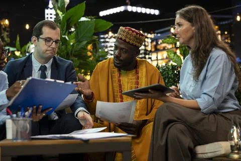 Close up of multinational businesspeople analyzing project documents on terrace Fotos de archivo