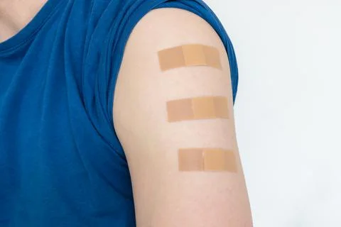 Close up of multiple bandages plasters on upper arm Stock Photos