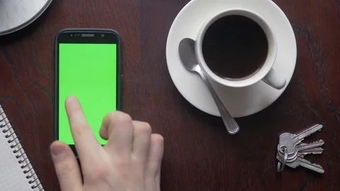 Close-up of multiple gestures on green screen of a smartphone at home Stock Footage 75457871