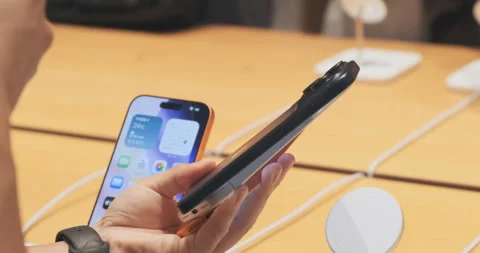 Close up, multiple iPhone 17 Pro Max models hold in hand in Apple Store inside Stock Footage 322051713