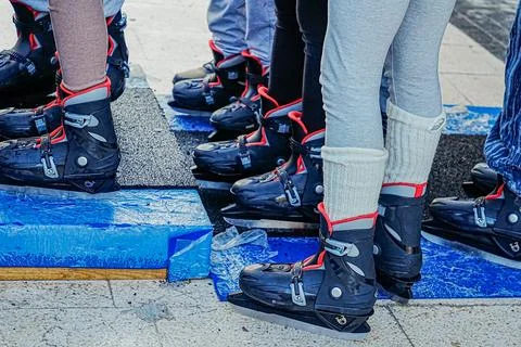 Close Up of Multiple Legs in Ice Skates Standing in Line Stock Photos