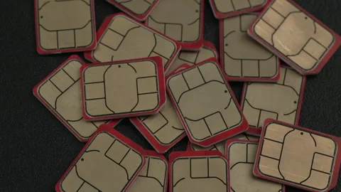 Close-Up of Multiple SIM Cards Arranged on Dark Surface Stock Footage 337267327