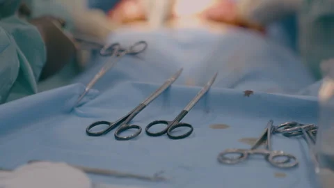 Close up multiple surgery tools on table in operating room team surgeons doctors 스톡 동영상 263082246