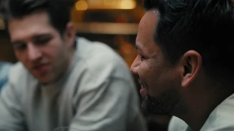 Close up of multiracial man drinking beer and friends in the background Stock-Footage 186539140