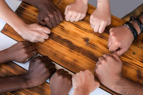 Close up of multiracial students hands making fist bump gesture. Stock Photos