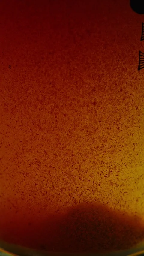 Close-up of a murky orange-brown liquid filled with dense rust particles and 스톡 동영상 340637196