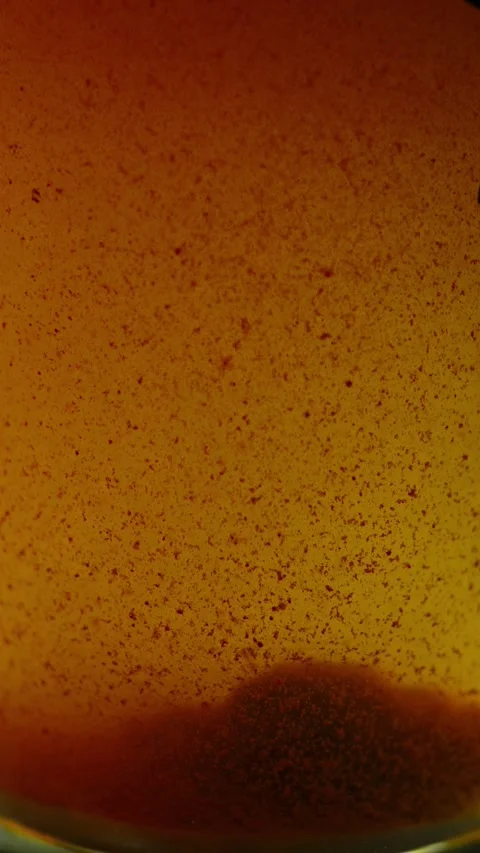 Close-up of a murky orange-brown liquid filled with dense rust particles and 스톡 동영상 340637382
