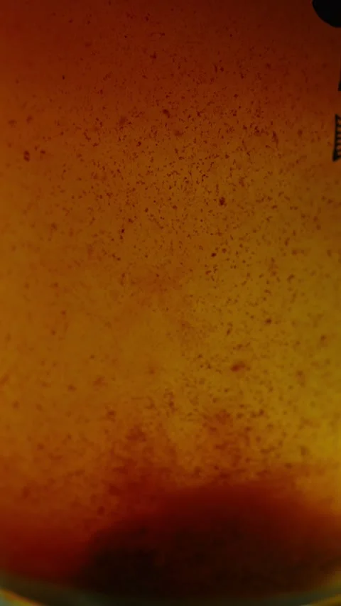 Close-up of a murky orange-brown liquid filled with dense rust particles and 스톡 동영상 340637431