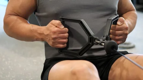 Close-up of a muscular man performing seated cable row exercise with parall.. Stock-Footage 344049153